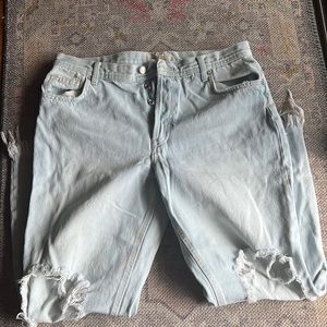 Free People denim pants. Size 31. Light wash. Fringed bottom and holes at knees